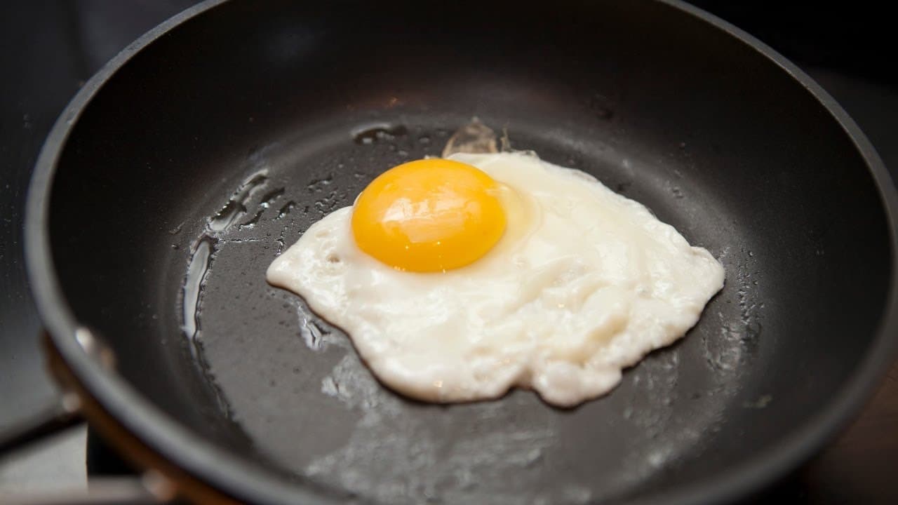 Proč se doporučuje přidávat ocet do pánve při smažení vajec?